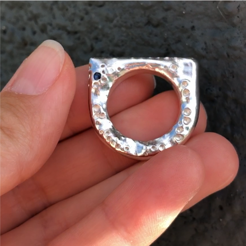 Silver ring with a blue faceted sapphire